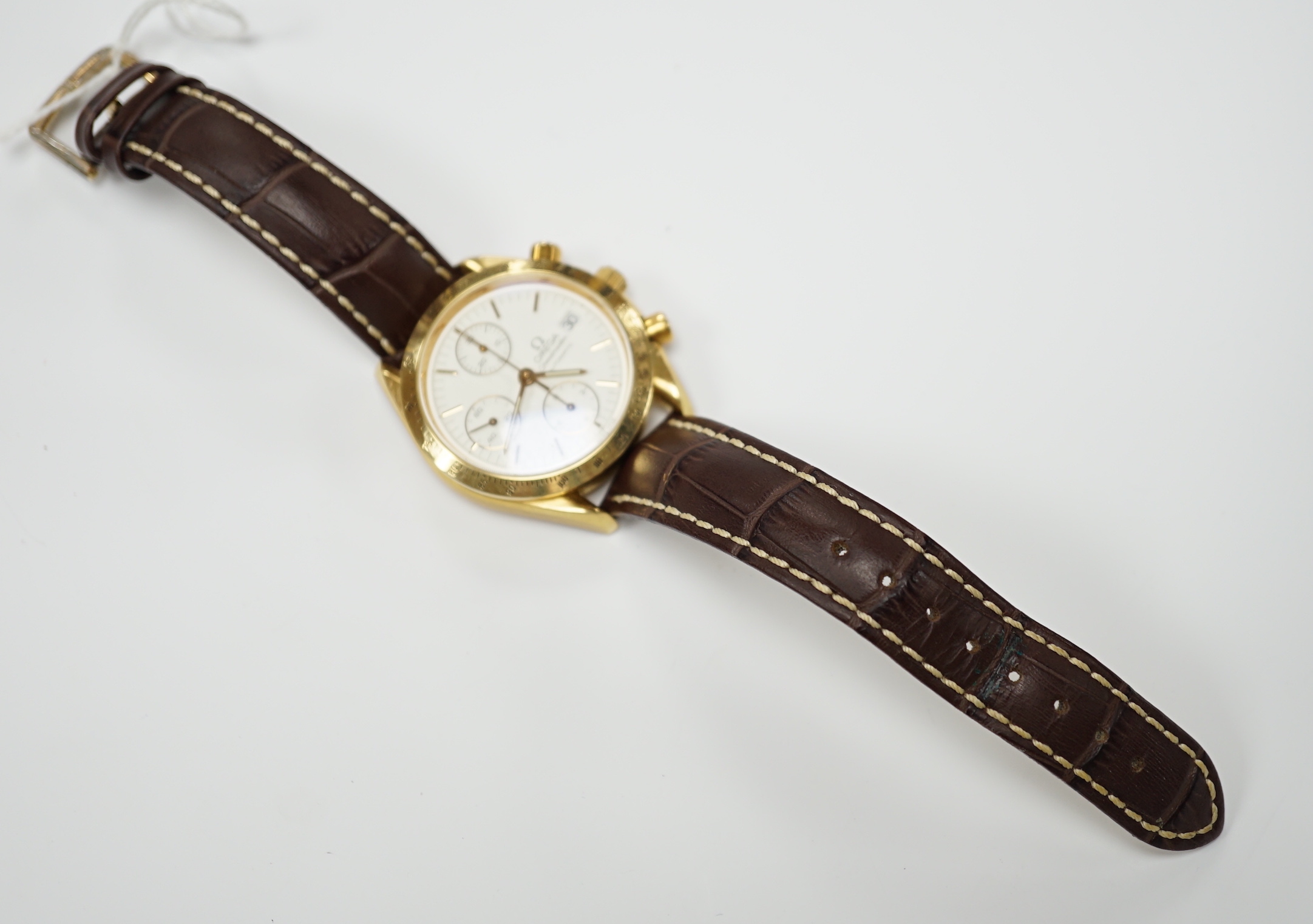 A gentleman's early 1990's 18ct gold Omega Speedmaster automatic wrist watch, with three subsidiary dials, ref. 1155, on later associated leather strap, with gold plated Omega buckle, with box and receipt (second hand).